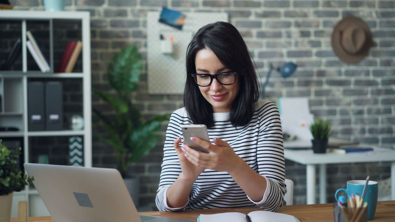 Professional smiling at her phone after receiving an instant refund